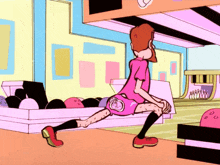 a girl in a pink shirt is stretching her legs