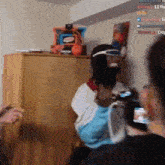 a man wearing a mask and goggles is standing in a room holding a remote control .