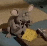 a cartoon mouse is eating cheese on a mouse trap