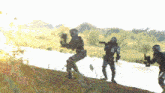 a group of soldiers are standing on a hill near a body of water