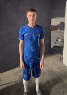 a young man wearing a blue nike shirt and shorts