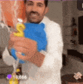 a man is holding a balloon with the letter s on it .