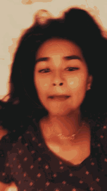 a girl wearing a necklace that says ' yves ' on it