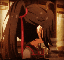 a close up of a ponytail with a red ribbon in it