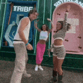 a group of people are dancing in front of a sign that says sisterland