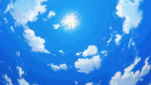 a blue sky with white clouds and a fireworks display in the middle