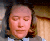 a woman with her eyes closed looks at the camera
