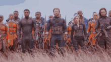 a group of avengers standing in a field with guns