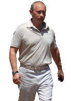 a man in a white shirt and white pants is walking with his hand on his hip