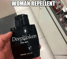a person is holding a bottle of deep hooken for men cologne .