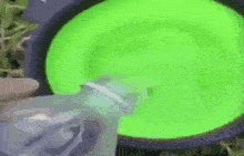 a close up of a green frisbee with a black ring around it