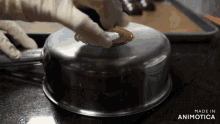 a pan with a lid that says made in animatica