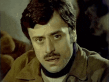 a close up of a man with a mustache