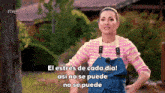 a woman wearing a pink and white striped sweater and a blue apron says el estrés de cada día