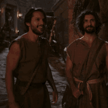 a couple of men standing next to each other holding hands