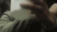 a blurry picture of a person 's hand reaching out towards the camera .