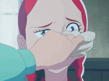 a girl with red hair is covering her mouth with her hand
