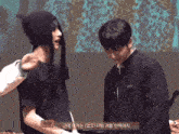 two men are standing next to each other and one of them is wearing a black hat