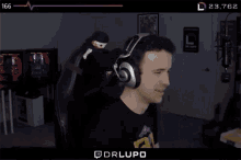 a man wearing headphones is laughing in front of a screen that says drlupo on it