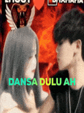 a man and a woman are looking at each other with the words dansa dulu ah written on the bottom