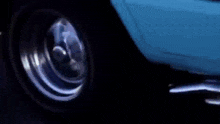 a man wearing blue gloves is holding a gun in his hand .