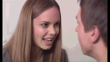 a man and a woman are looking at each other