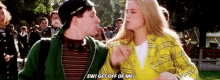 a man and a woman are kissing in a park and the woman is saying `` ew ! get off of me ! ''