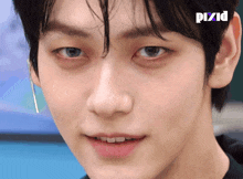 a close up of a person 's face with pixid written on the bottom right