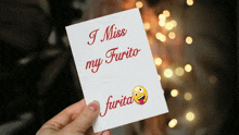 a person is holding a card that says i miss my furto furta