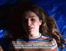 a woman in a striped sweater laying on a blue tarp says " i know you 're here cause you need me "