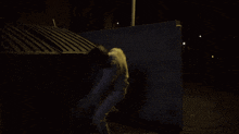 a shadow of a person is cast on a dark wall