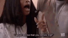 a woman is talking to a man in a room and says `` i would advise that you rethink that ! ''