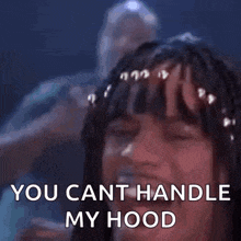 a woman with braids in her hair is laughing and saying `` you cant handle my hood '' .