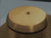 a gold bell with a small knob on it