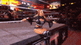 a female wrestler in a wrestling ring with a sign that says abbey reid