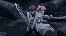 a man and a woman are standing next to each other holding swords in a dark room .