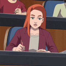 a woman with red hair is sitting in a classroom with other students