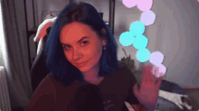 a girl with blue hair is wearing a t-shirt that says ' i love you ' on it