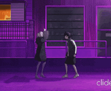 a man and a woman are standing next to each other in front of a purple building ..