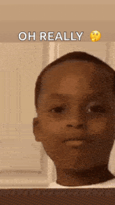 a young boy is making a funny face with the words `` oh really '' written above him .