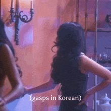 a woman in a black dress stands in front of a wall with the words gasps in korean