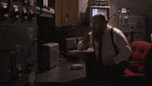 a man sitting in a chair with the words do it now behind him