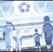a group of soccer players are standing in a stadium watching a game .