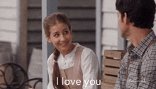 a man and a girl are sitting on a porch and the girl is saying i love you