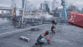 a man in a spiderman costume is kneeling down in front of a red container that says eee