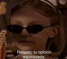 a young girl wearing sunglasses and a headband is making a funny face and saying respecto tu opinion equivocada .