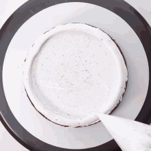 a cake is being frosted with white frosting