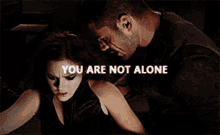 a man and a woman with the words you are not alone