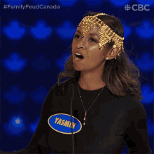 a woman wearing a headpiece and a name tag that says yasmin