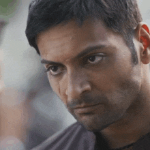 a close up of a man 's face with sweat on his face